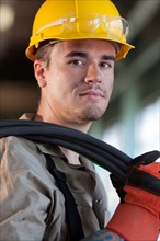 Portrait of male manual worker wearing hardhat. Photo: db2stock