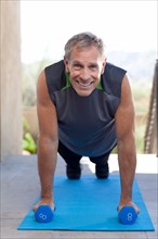 Portrait of senior man doing push-ups. Photo : db2stock