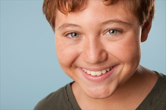 Studio portrait of boy (12-13) smiling. Photo: Rob Lewine