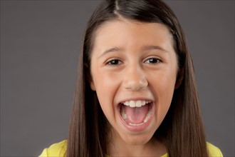 Portrait of screaming girl (8-9), studio shot. Photo : Rob Lewine
