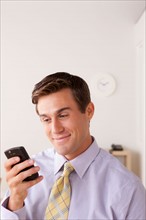 Businessman text-messaging. Photo: Rob Lewine