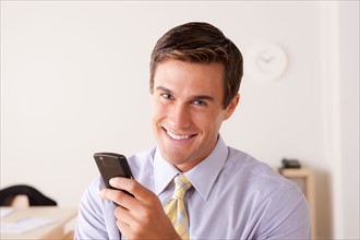 Portrait of businessman text-messaging. Photo : Rob Lewine