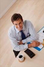 Portrait of young smiling businessman in office. Photo : Rob Lewine
