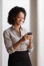 Portrait of smiling businesswoman on phone. Photo : Rob Lewine