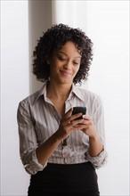 Portrait of smiling businesswoman on phone. Photo : Rob Lewine