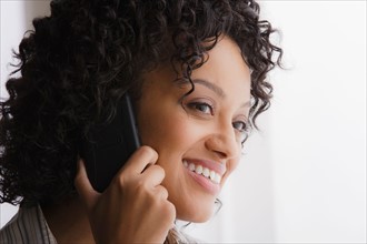 Portrait of smiling businesswoman on phone. Photo : Rob Lewine