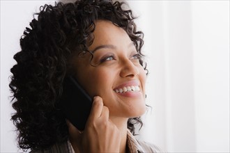 Portrait of smiling businesswoman on phone. Photo : Rob Lewine