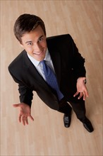 Portrait of young smiling businessman gesturing. Photo: Rob Lewine