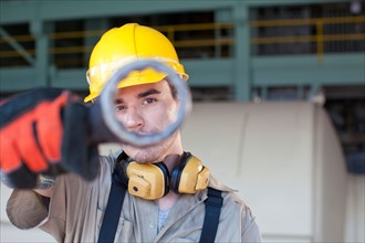 Portrait of male manual worker holding tool. Photo: db2stock
