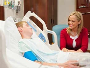 Mother visiting son (10-11) in hospital.