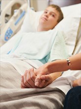 Mother visiting son (10-11) in hospital.