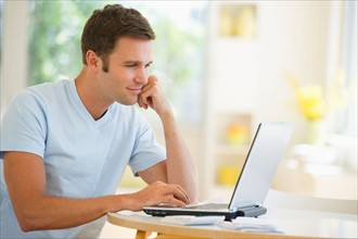 Young man using laptop.