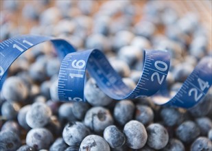 Close up of frozen blueberries in jar and measuring tape. Photo : Jamie Grill