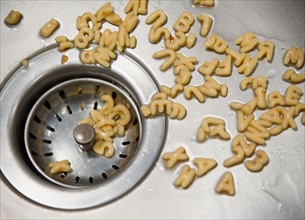 Close up of letter noodles in kitchen sink. Photo: Jamie Grill