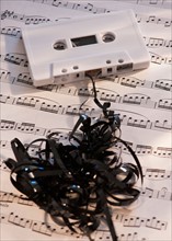White mix tape on sheet music, studio shot. Photo : Daniel Grill