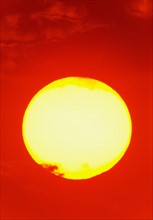 Close-up of large red sun.