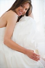 Portrait of smiling woman in wedding dress. Photo : Jamie Grill