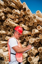 Engineer in front of stack of timber. Photo: Erik Isakson