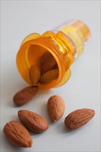 Studio shot of pill bottle with almonds. Photo: Winslow Productions