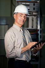 Portrait of male technician wearing hardhat. Photo : db2stock