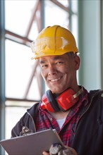 Portrait of male manual worker wearing hardhat. Photo : db2stock