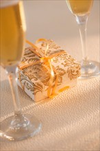 Flutes with champagne and small gift box. Photo: Daniel Grill