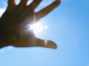 Hand in front of sun.