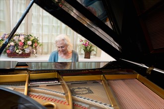Senior woman playing piano.
