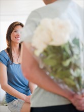 Man bringing bouquet to woman. Photo: Jamie Grill