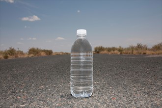 Water bottle sitting in middle of desert road. Photo: Winslow Productions
