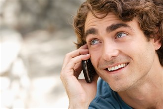 Portrait of young man talking on phone. Photo: Rob Lewine