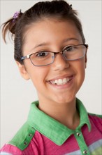 Studio portrait of girl (8-9) wearing eyeglasses. Photo: Rob Lewine