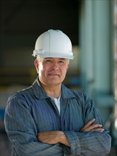 Portrait of industrial worker wearing hardhat. Photo : db2stock