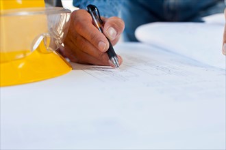 Architect's hand drawing blueprint. Photo : db2stock