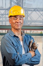 Portrait of worker wearing hardhat. Photo : db2stock