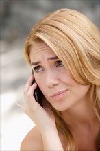 Portrait of young woman talking on phone. Photo : Rob Lewine