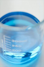 Studio shot of laboratory beaker with blue liquid. Photo : Antonio M. Rosario
