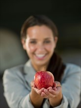 Business woman holding apple. Photo : db2stock