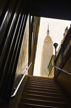 Empire State Building as seen from subway station staircase.