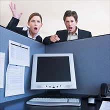 Office workers shouting in office cubicle. Photo : Daniel Grill