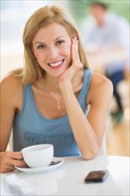 Portrait of mid adult woman drinking coffee.