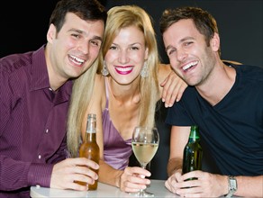 Portrait of group of friends drinking in nightclub.