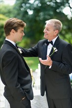 Father talking with groom.