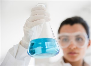 Female lab technician holding viale. Photo : Jamie Grill
