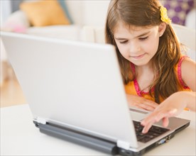 Girl ( 6-7) using laptop. Photo: Jamie Grill