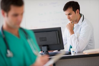 Doctor looking at computer.