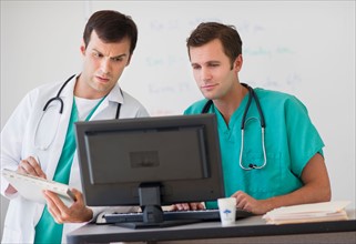 Doctors looking at computer.