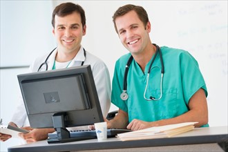 Portrait of two doctors using computer.