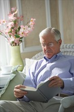 Senior man reading book.