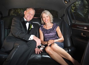 Portrait of parents of bride in limousine.